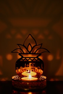 a lit candle sitting on top of a table