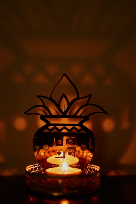 a lit candle sitting on top of a table
