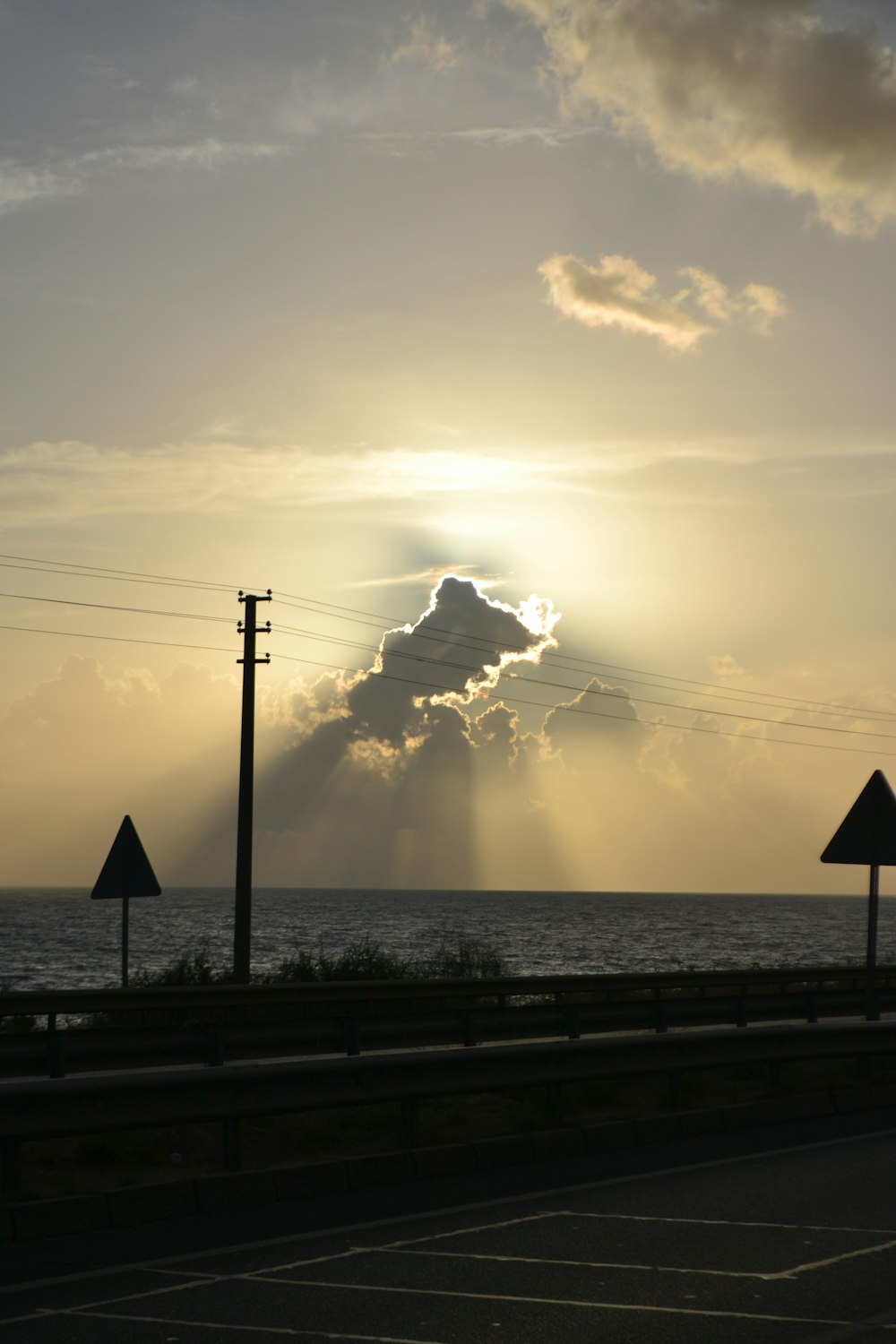 the sun is shining through the clouds over the ocean