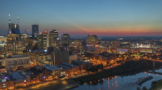 a view of a city at night from the top of a hill