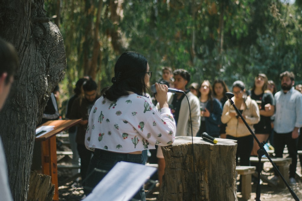 a woman standing in front of a group of people