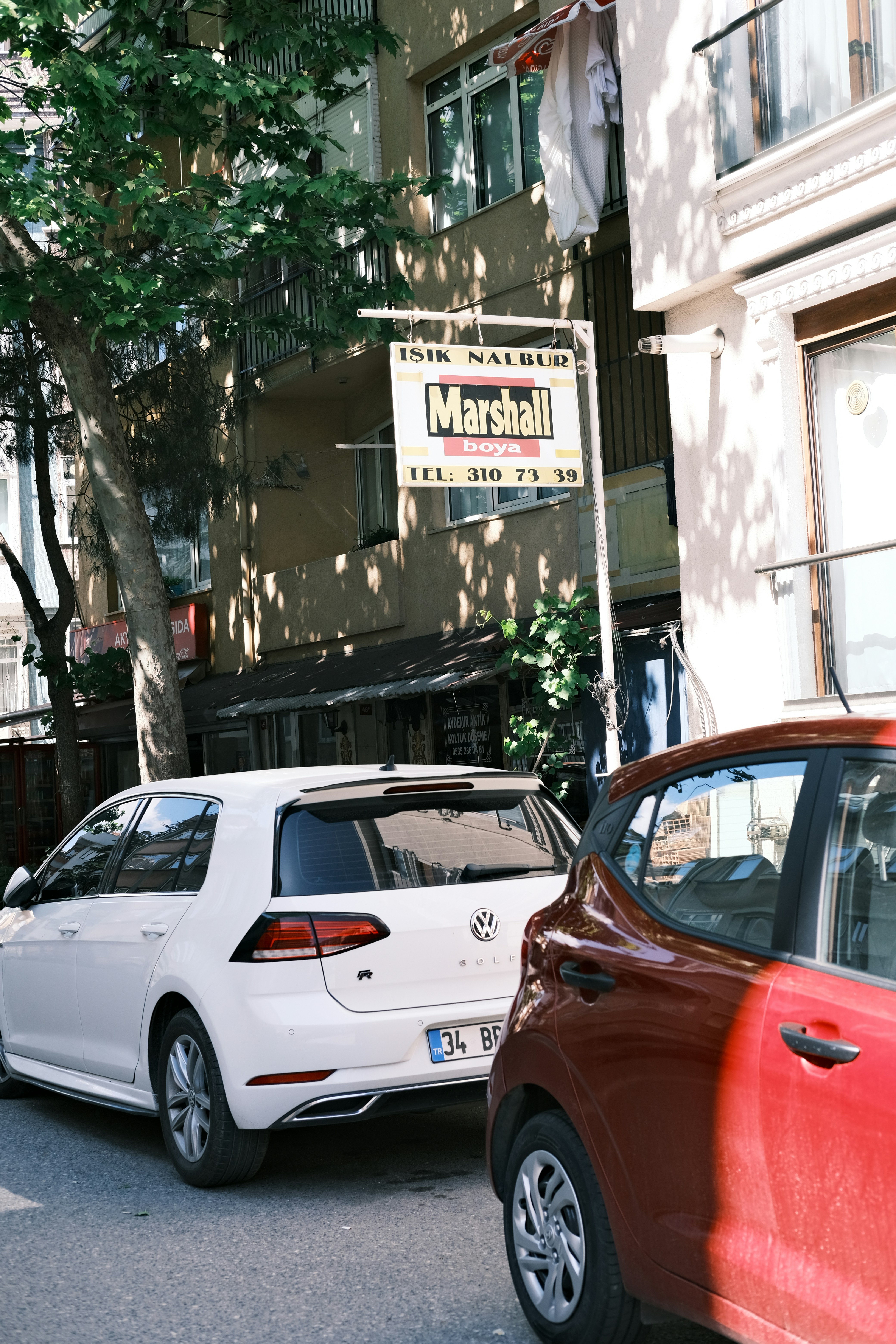a couple of cars parked on the side of a road