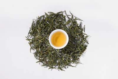 a cup of green tea on a white background