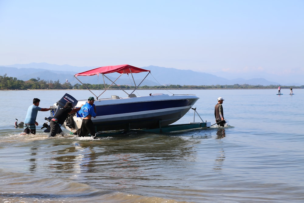 a group of people standing on a boat in the water