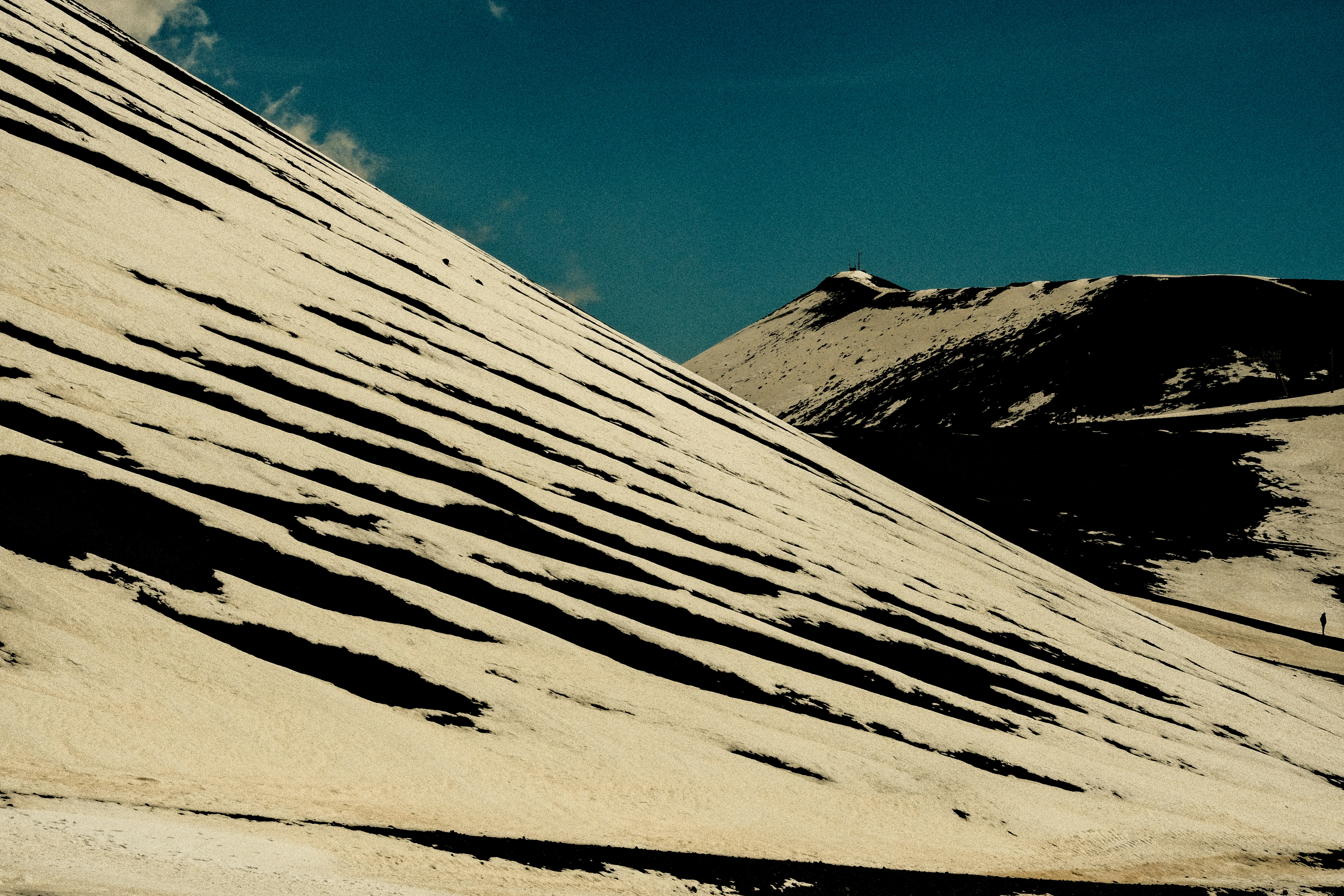 a man riding a snowboard down a snow covered slope
