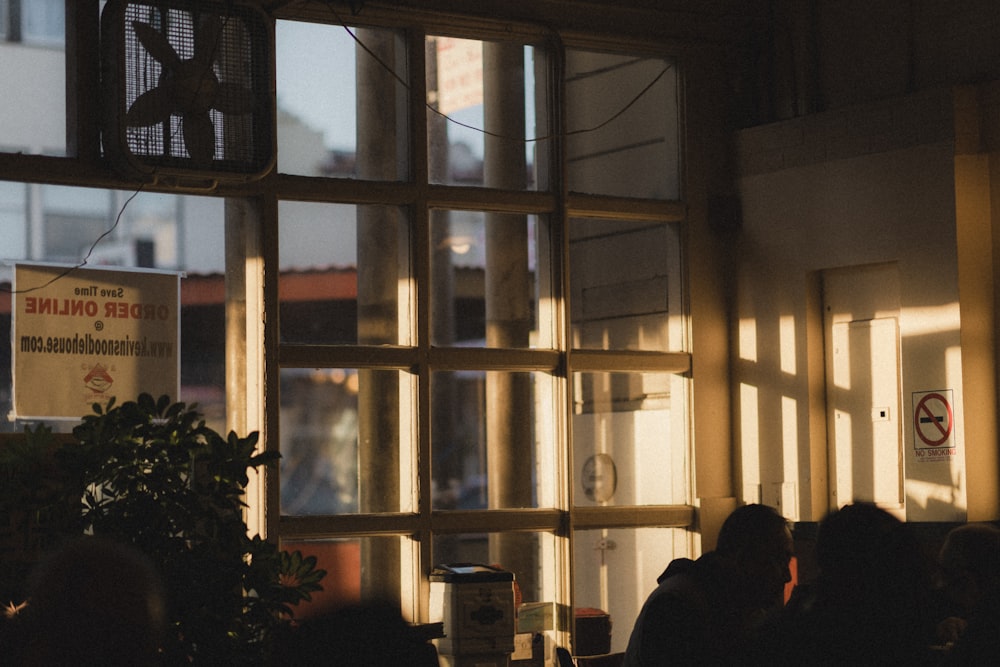 a group of people sitting in front of a window