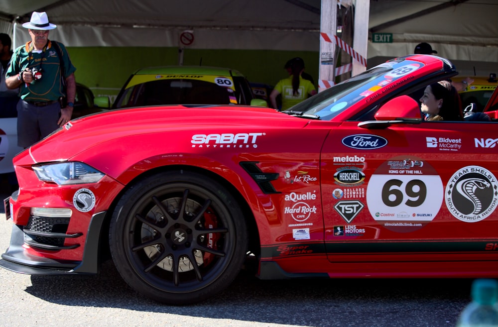 a red sports car with a number on it