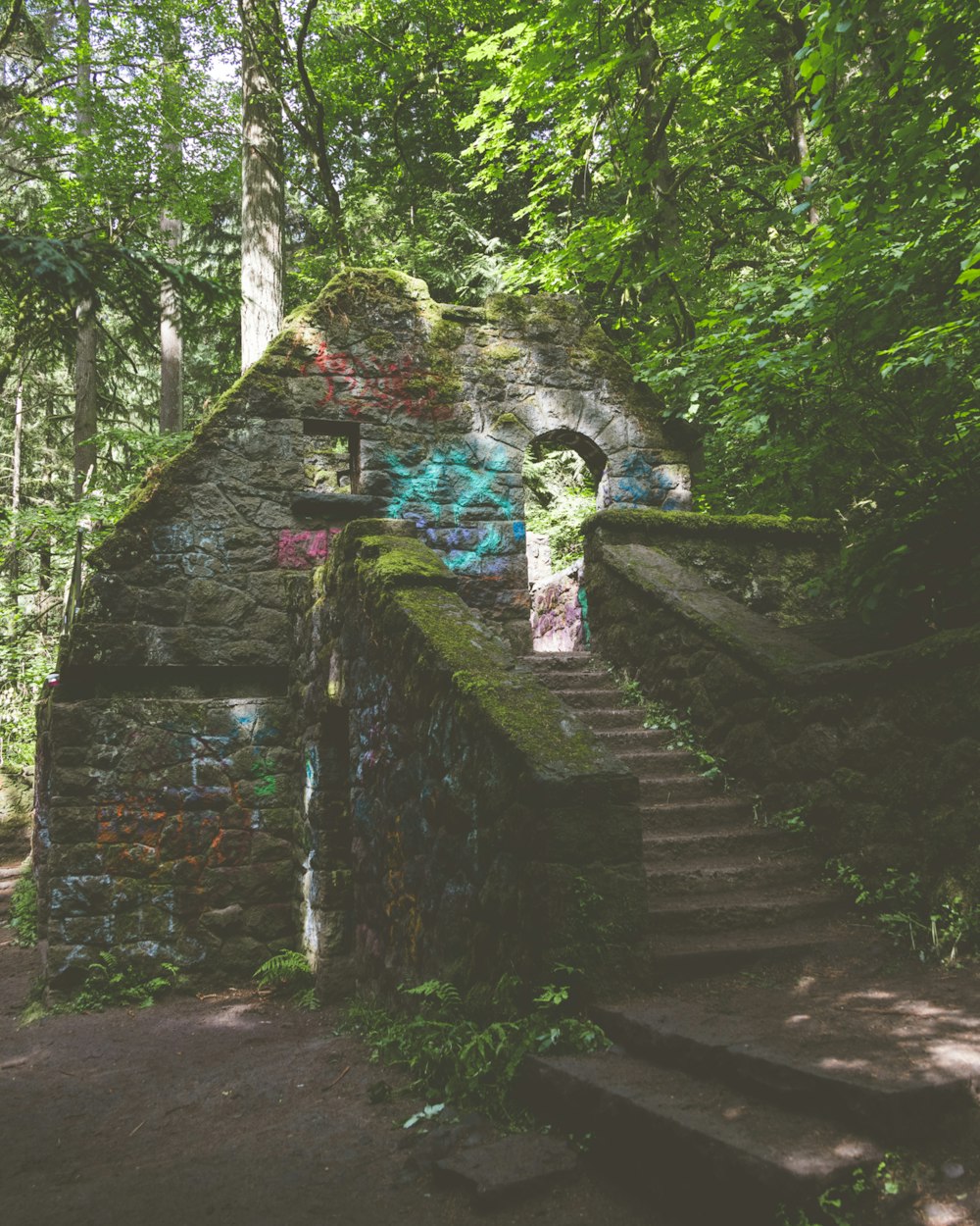 a stone building with graffiti on the side of it