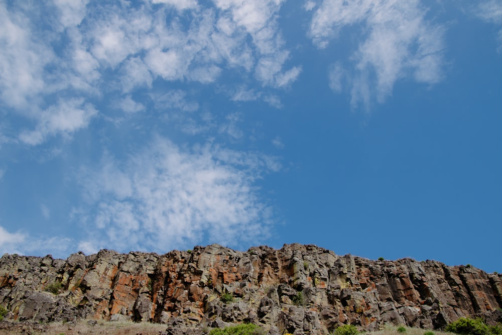 a large rock formation with a blue sky in the background