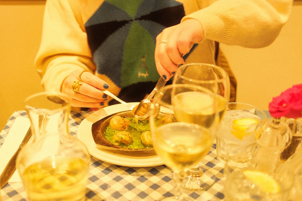 a woman sitting at a table with a plate of food