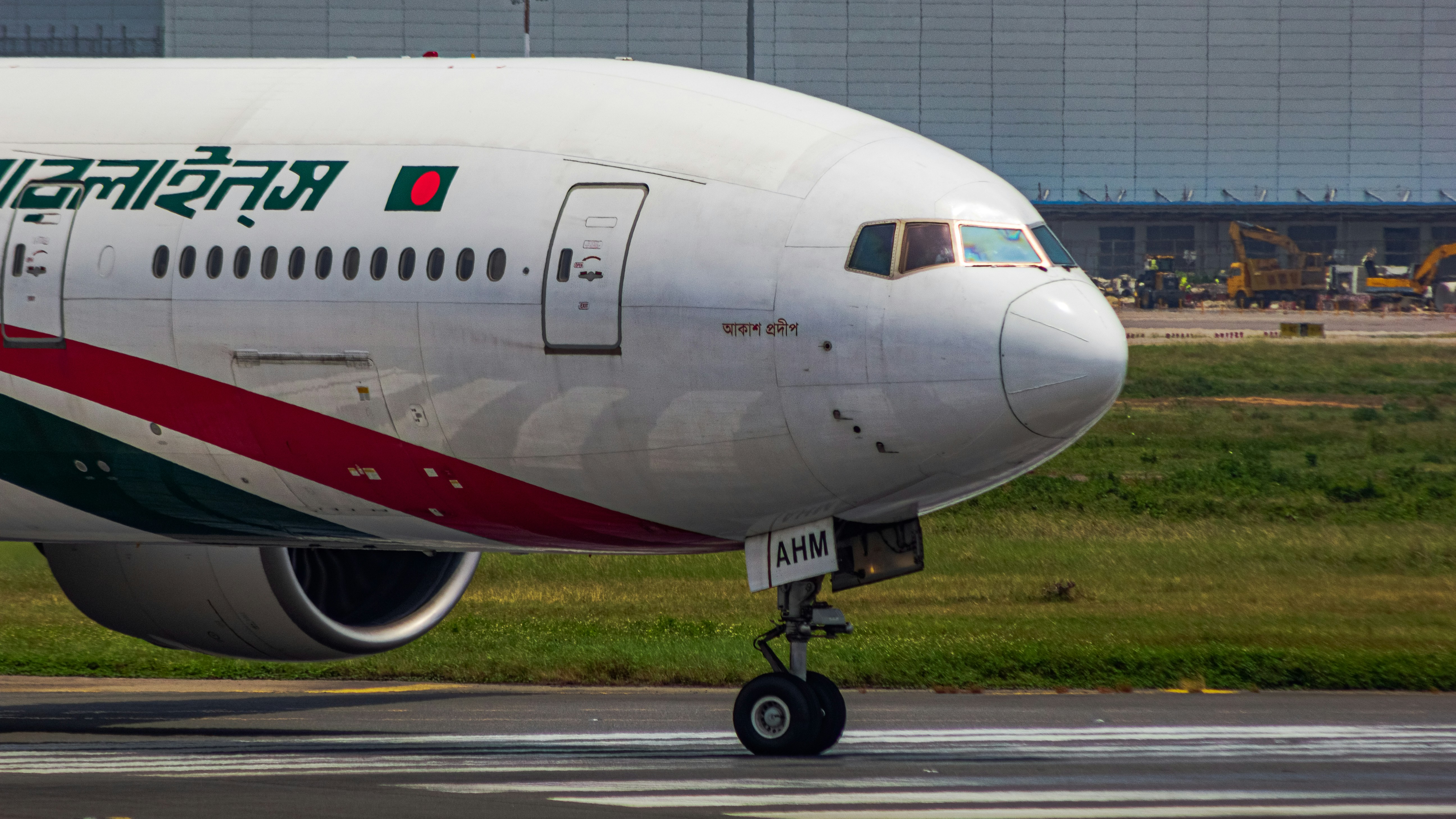 a large jetliner sitting on top of an airport runway, Front angry face of Biman Bangladesh Airline