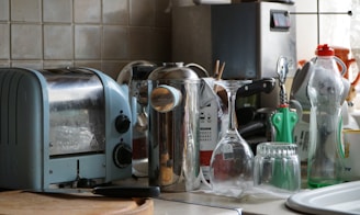 a kitchen counter with a toaster, toaster, and other kitchen items