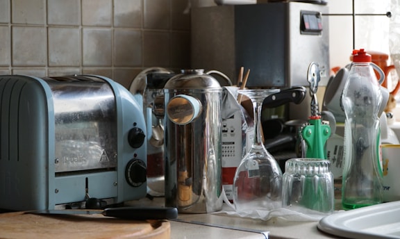 a kitchen counter with a toaster, toaster, and other kitchen items