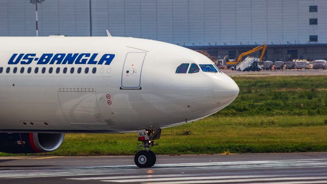 a large jetliner sitting on top of an airport runway, US-Bangla Airlines A330