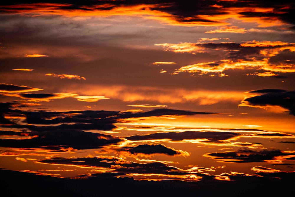 the sun is setting over the clouds in the sky