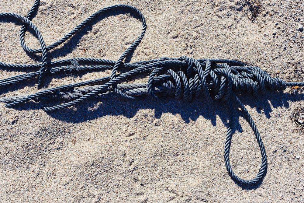 a rope lying on the sand on a beach