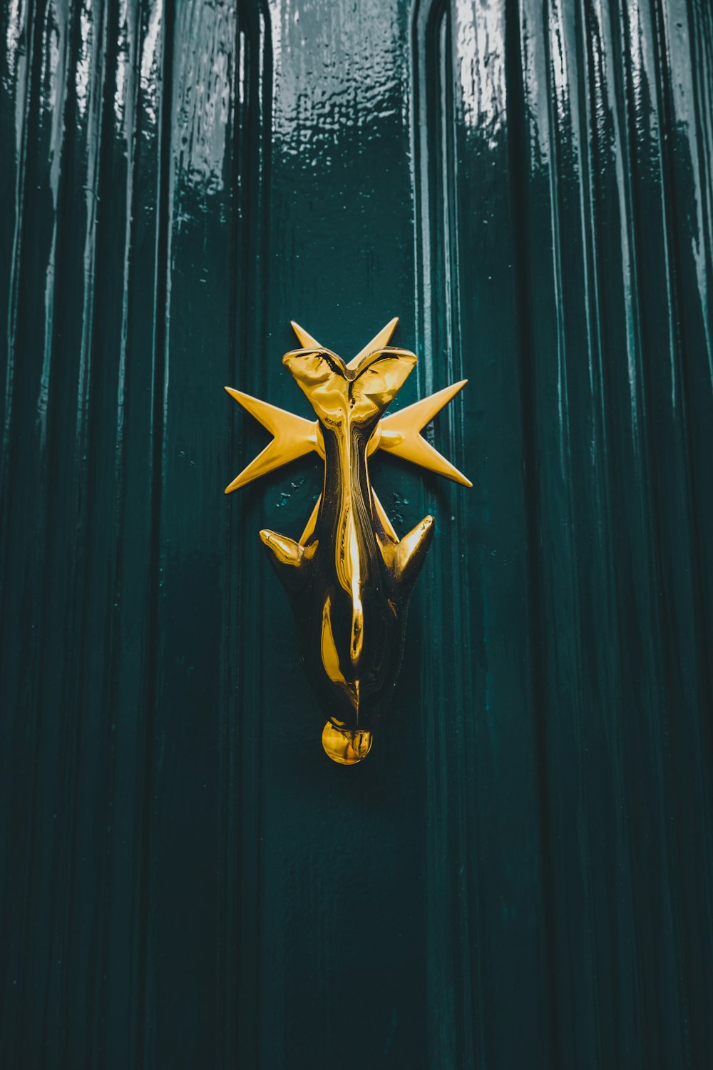 a green door with a gold door knocker on it