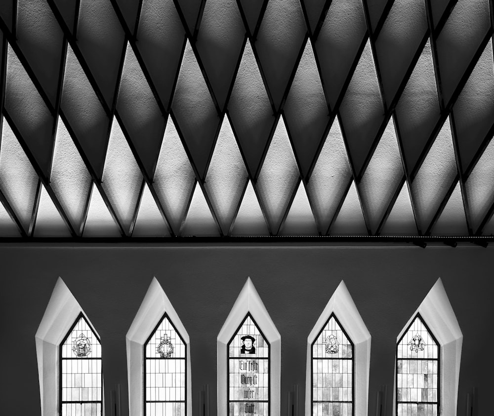 a black and white photo of a church with four windows