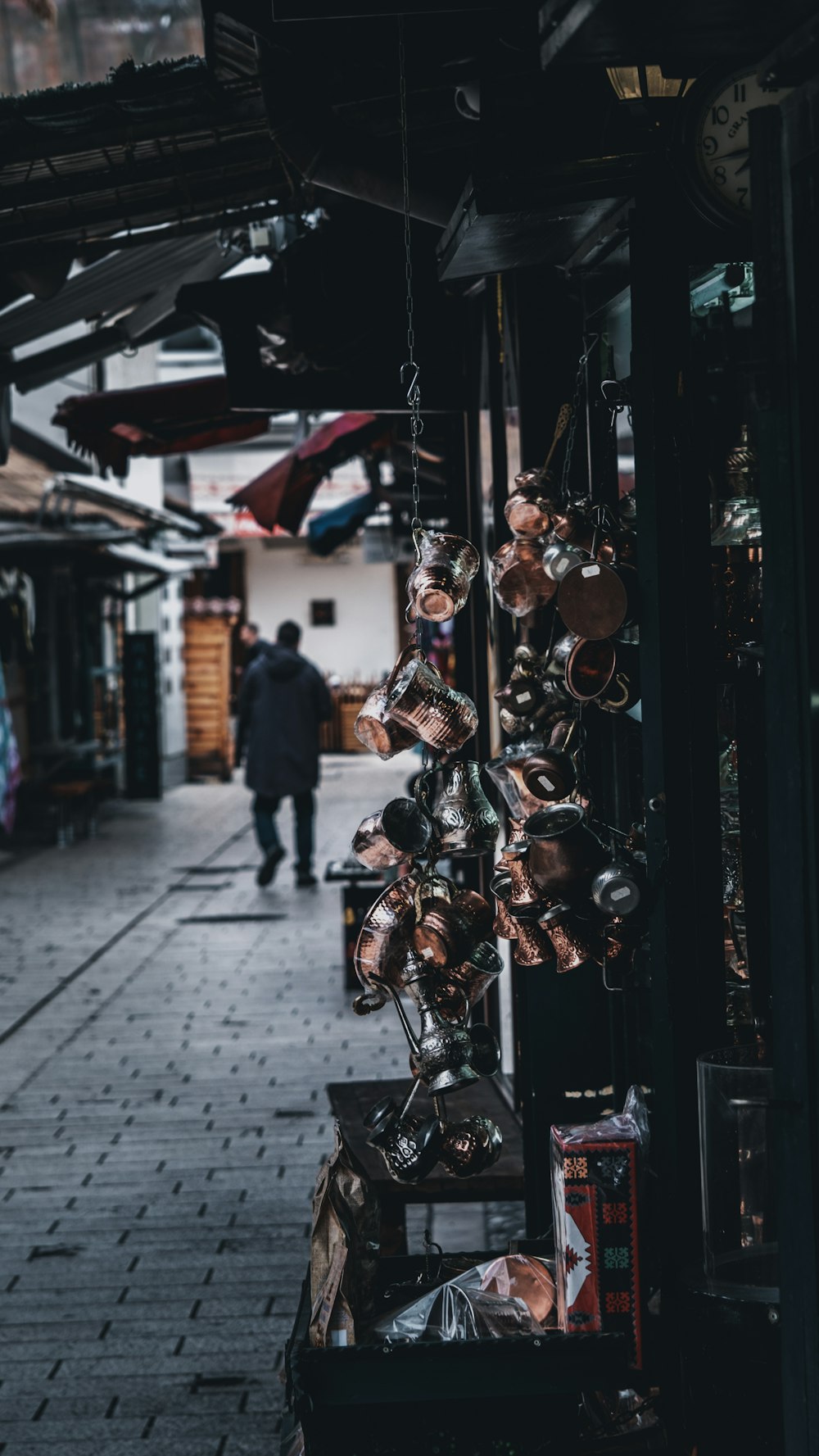 a man walking down a street next to a store