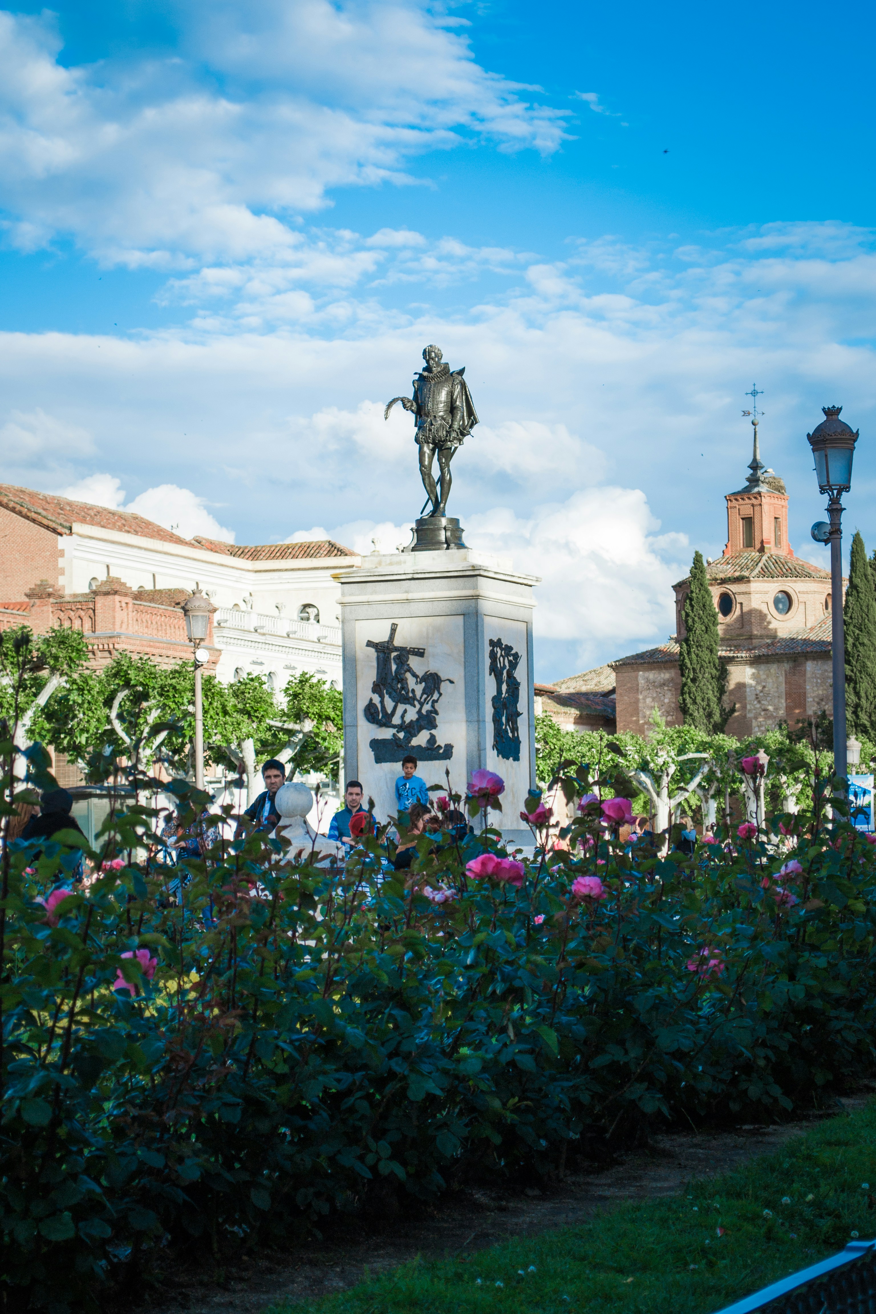 a statue of a man riding a horse in a garden