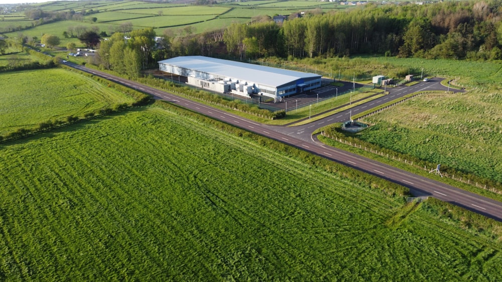 an aerial view of a farm and a road