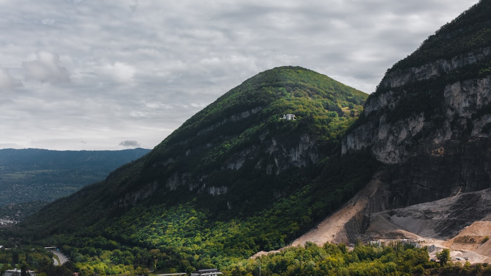 a scenic view of a valley with mountains in the background