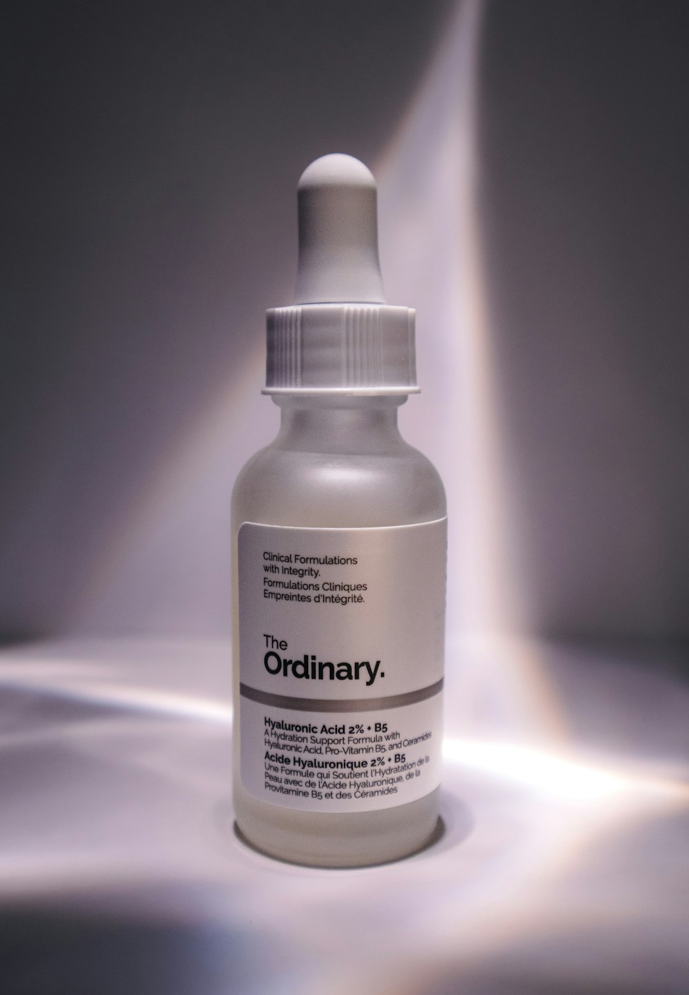 a bottle of the ordinary solution on a gray background