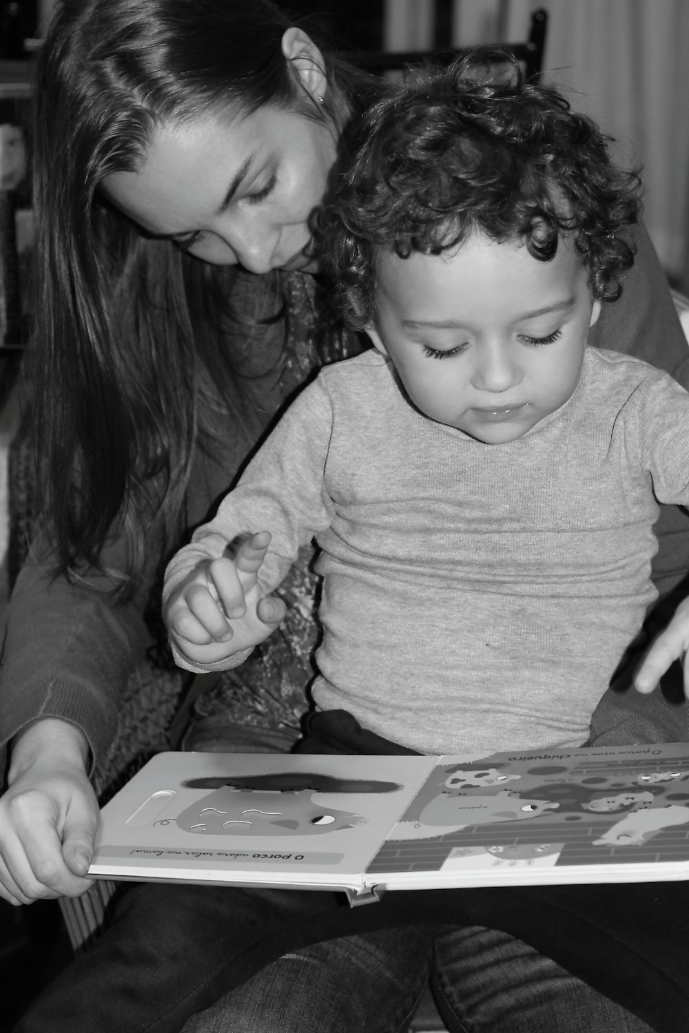 a woman reading a book to a child