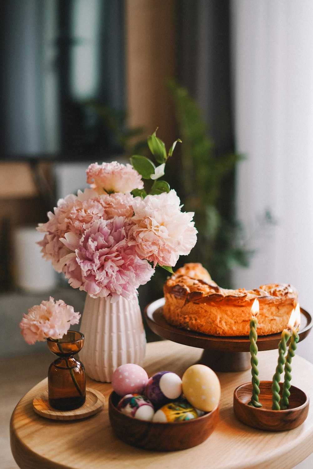 a table topped with a cake and flowers