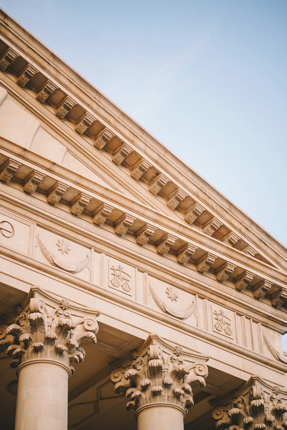 a close up of a building with columns and a clock