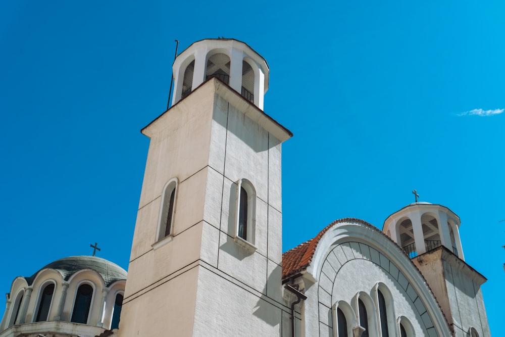 a church with two steeples and a blue sky in the background