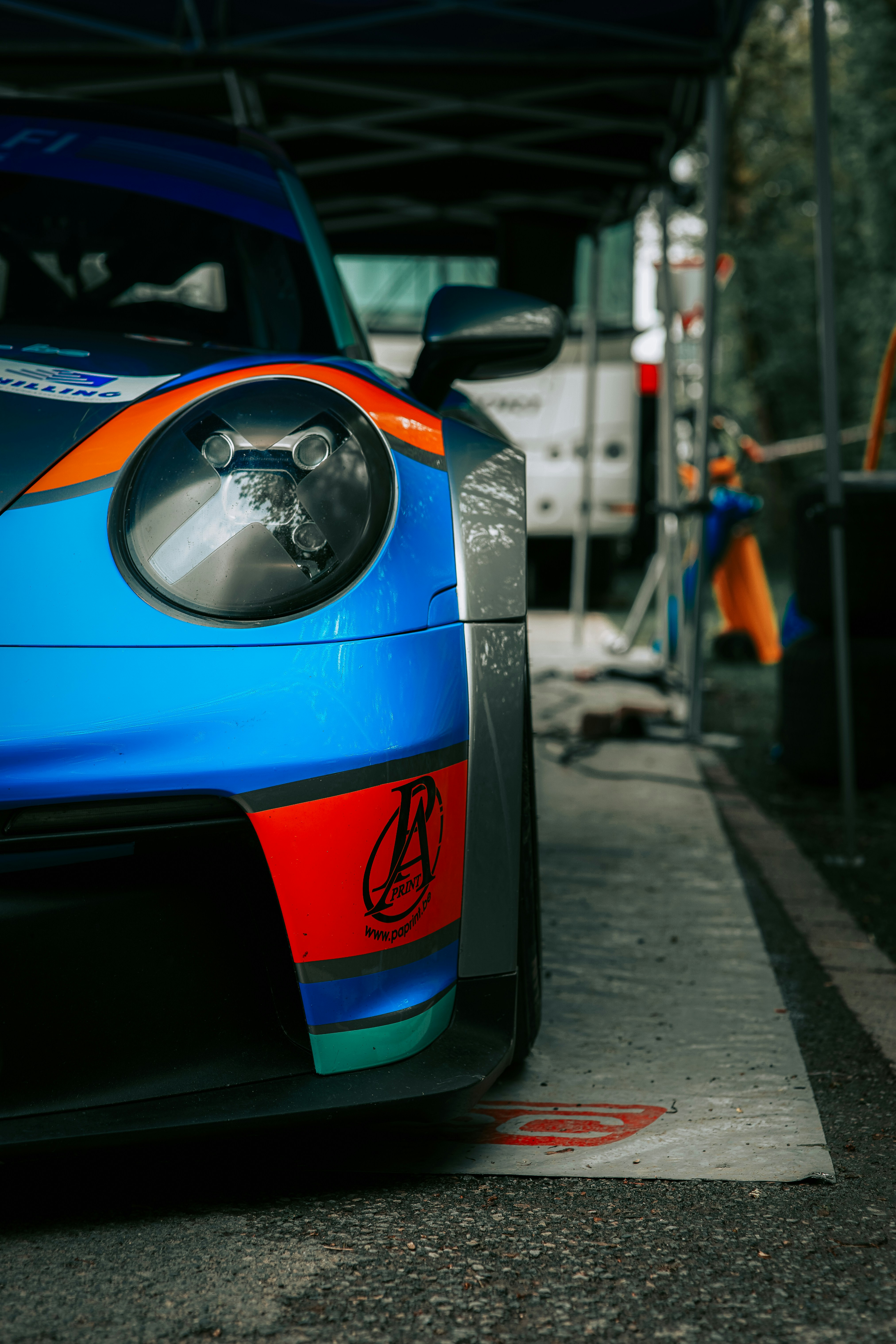 a blue sports car parked on the side of the road
