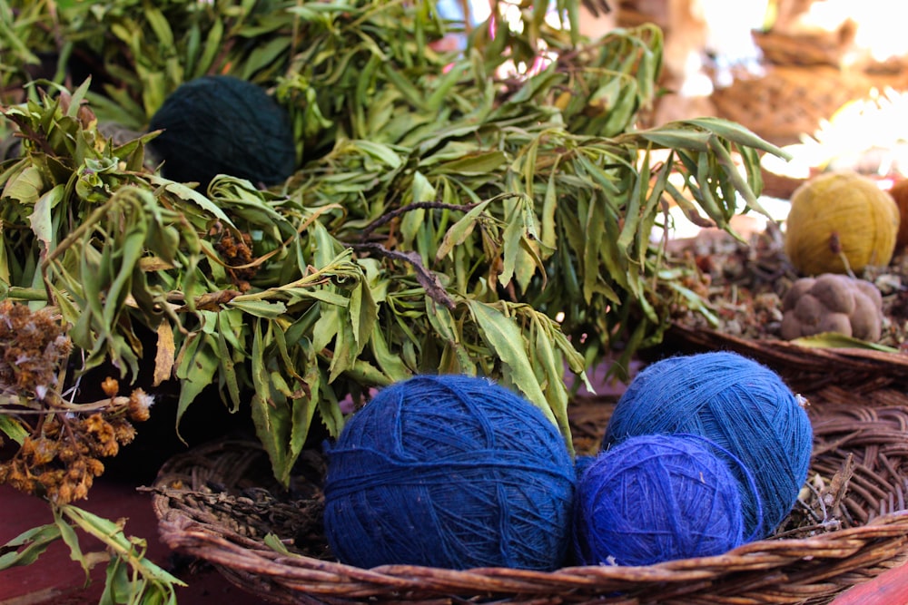 a basket filled with blue balls of yarn
