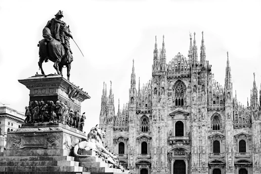 a black and white photo of a statue of a man on a horse