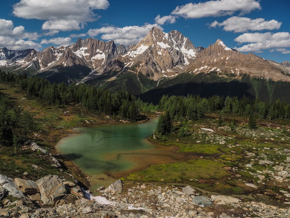 a mountain range with a lake in the foreground