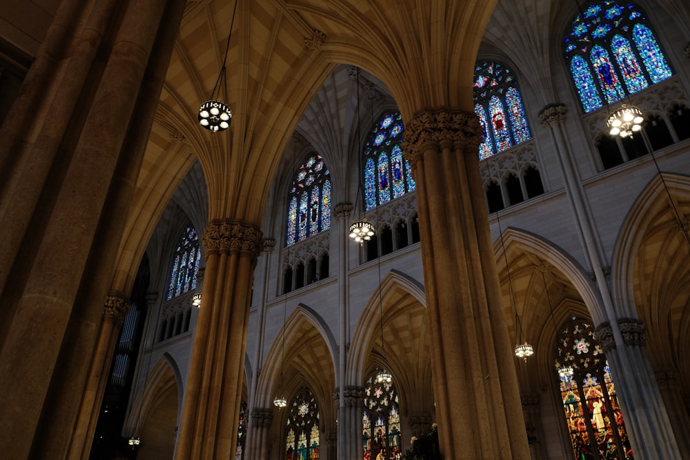 the inside of a cathedral with stained glass windows