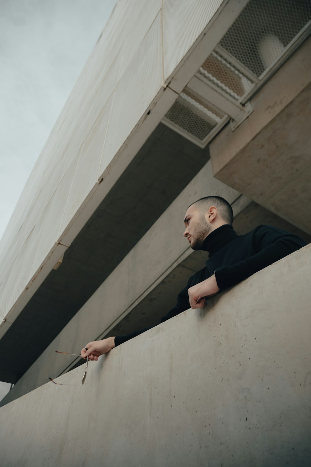 a man leaning against a wall with his hand on the wall