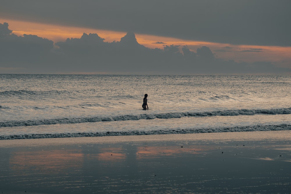 a person standing on a surfboard in the ocean