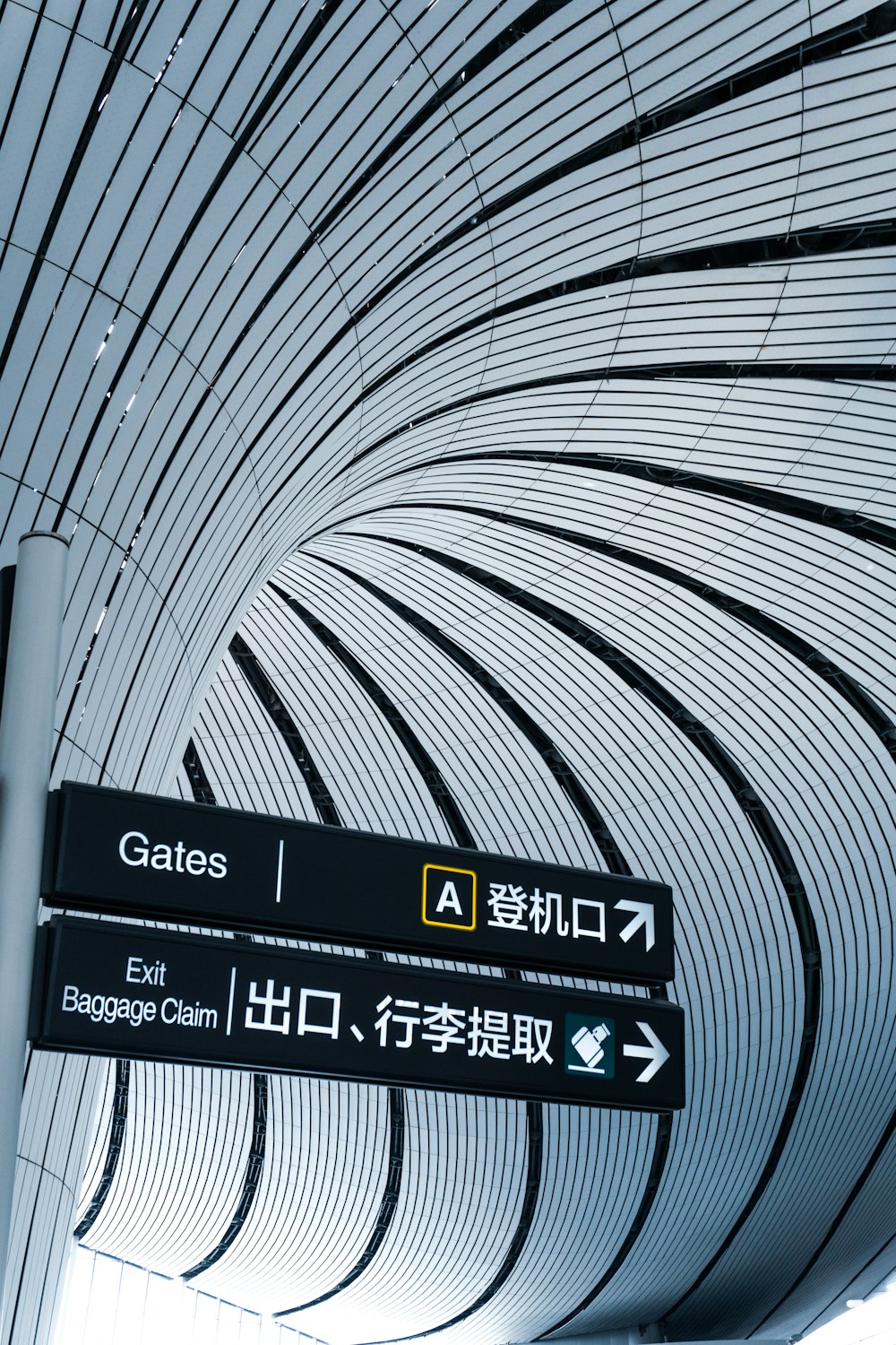 a sign in an airport pointing in different directions