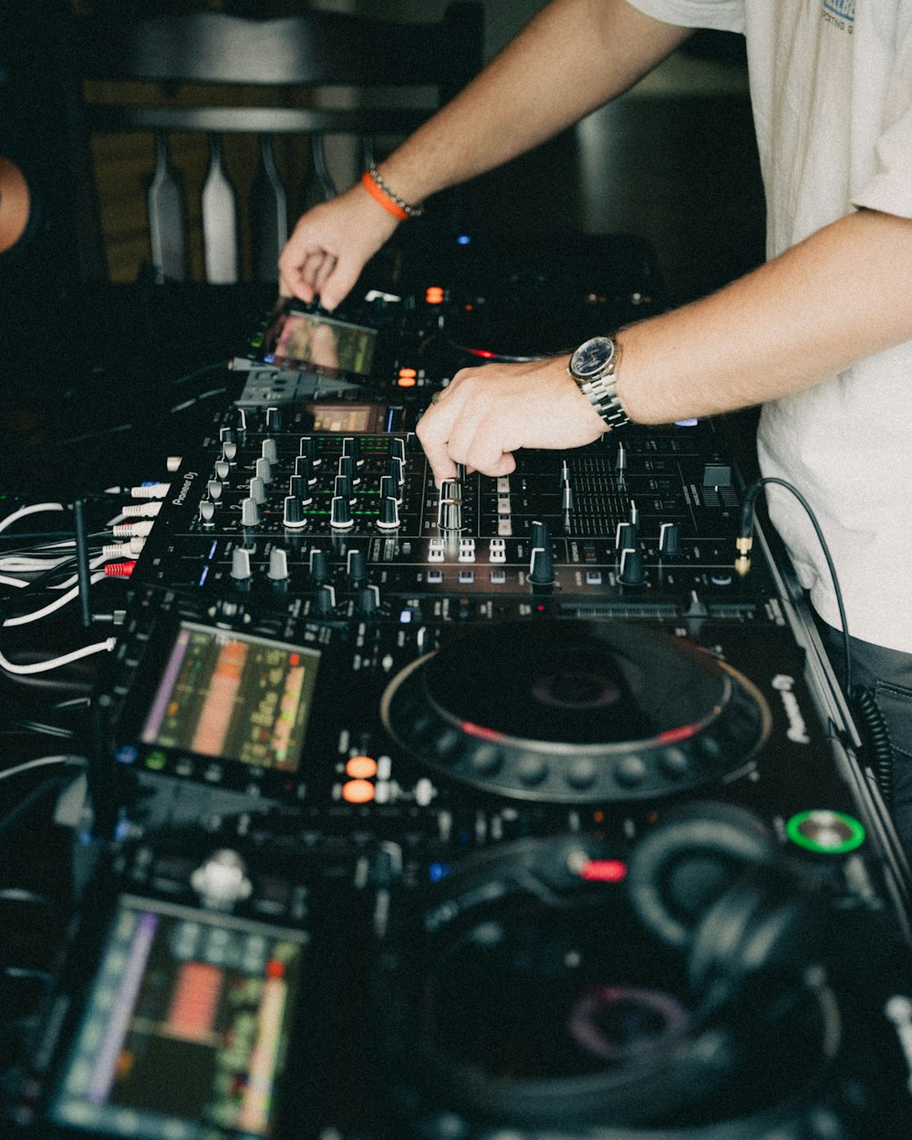 a dj mixing music on a large set of decks