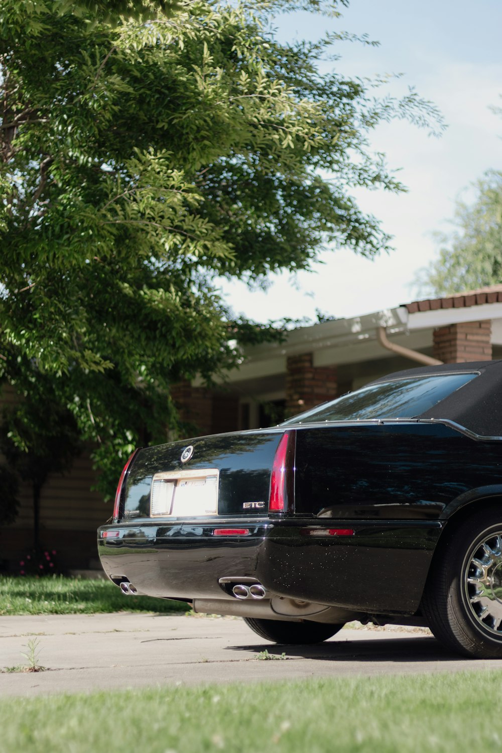 a black car parked in front of a house