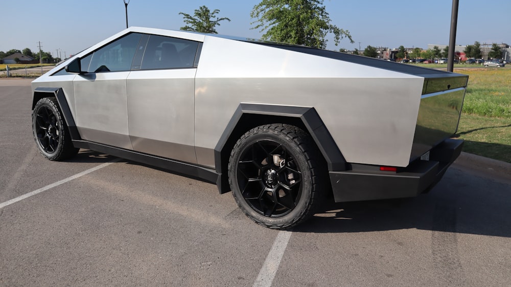 a silver and black car parked in a parking lot