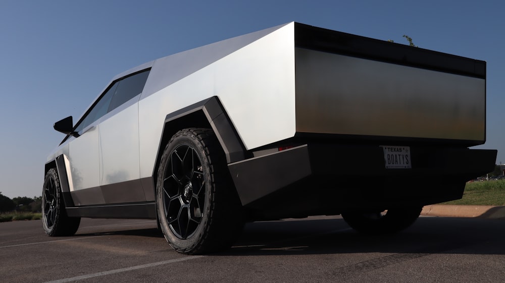 a white and black truck parked in a parking lot