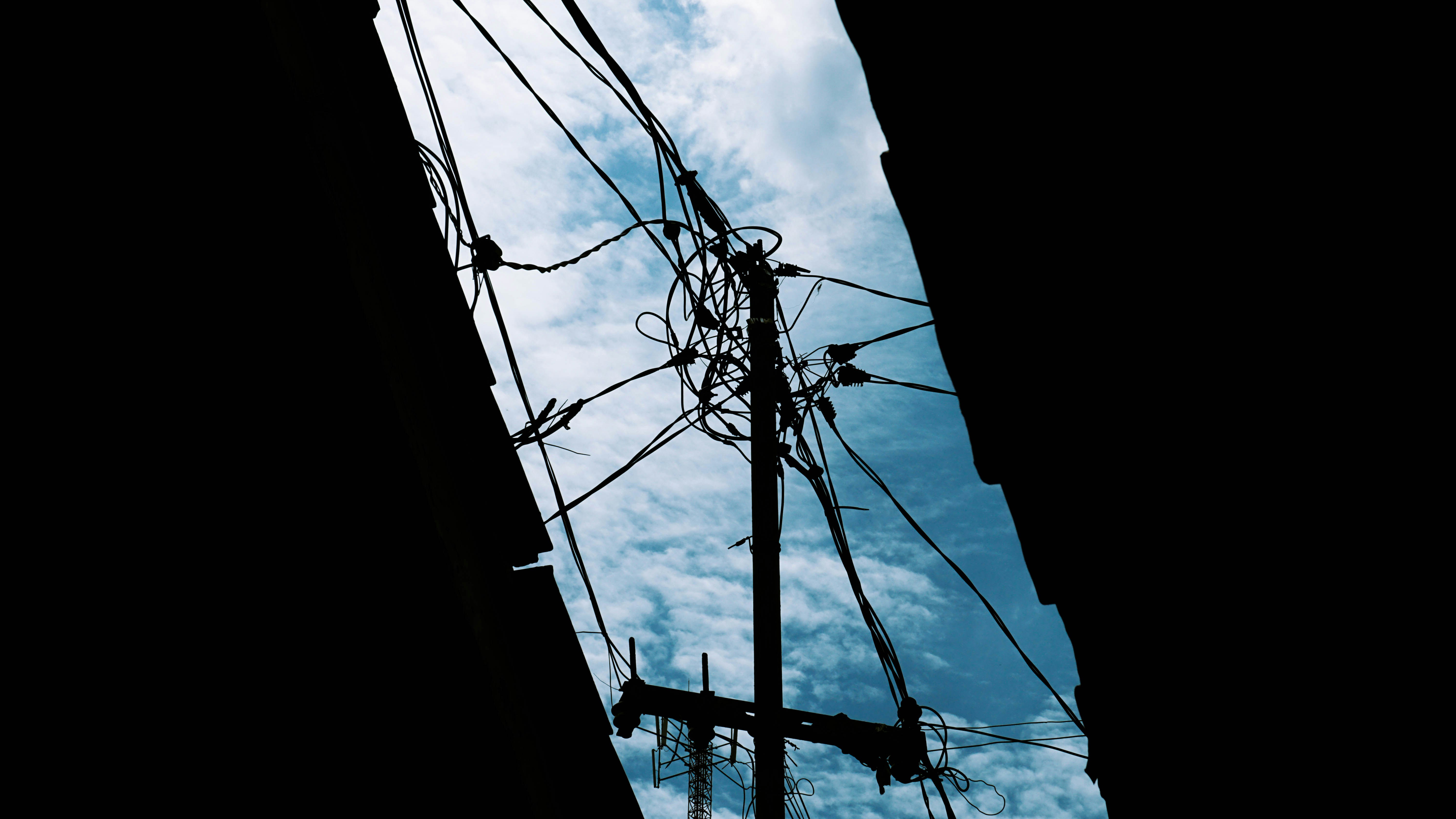 a telephone pole with a sky in the background