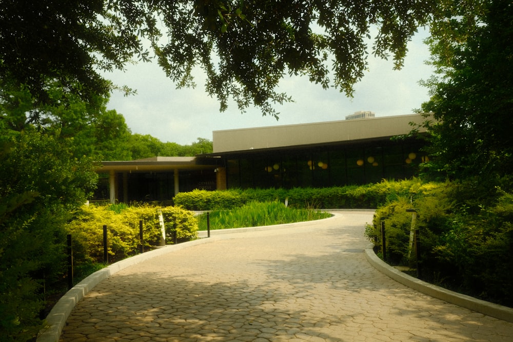 a large building sitting next to a lush green forest