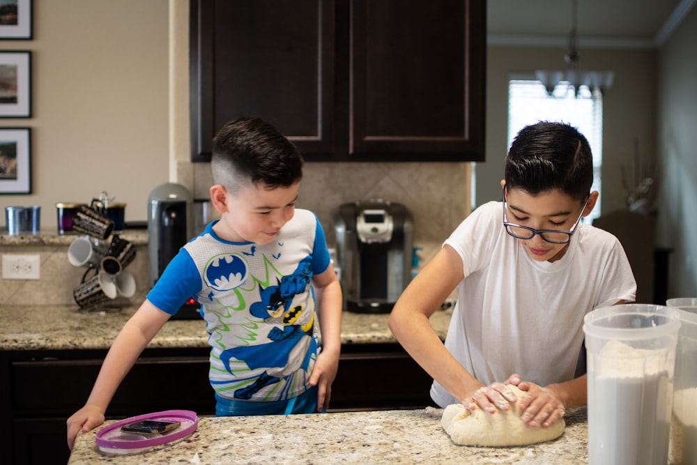 a boy and a boy making a doughnut together