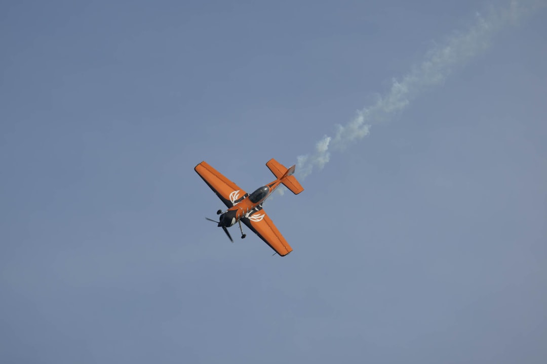 a small airplane flying through a blue sky, Russian-made aerobatic aircraft model Sukhoi-31 with serial number EC-MKU du