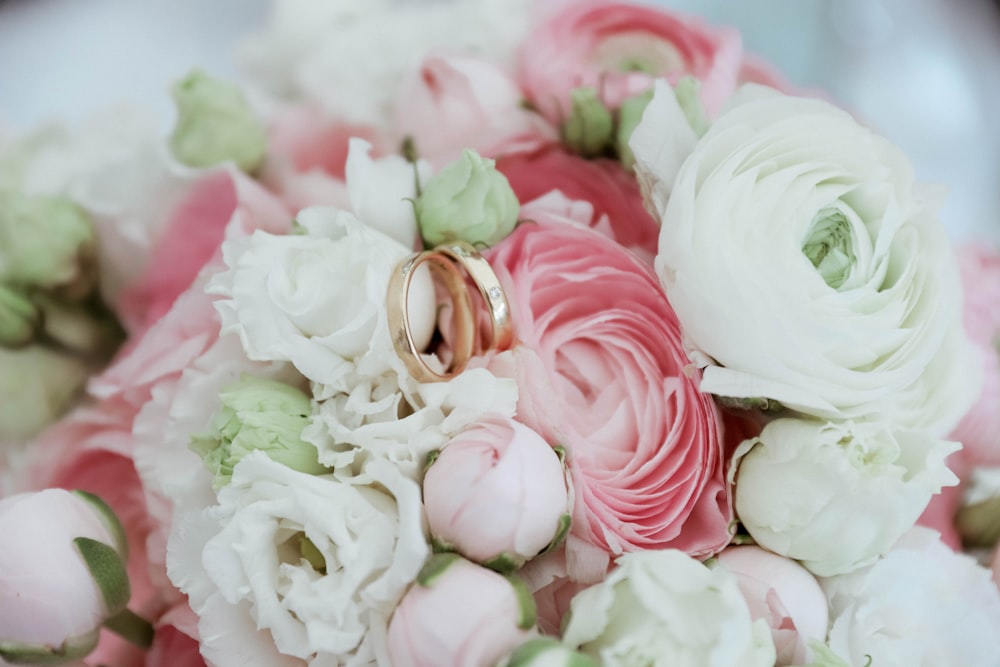 a bouquet of flowers with two wedding rings