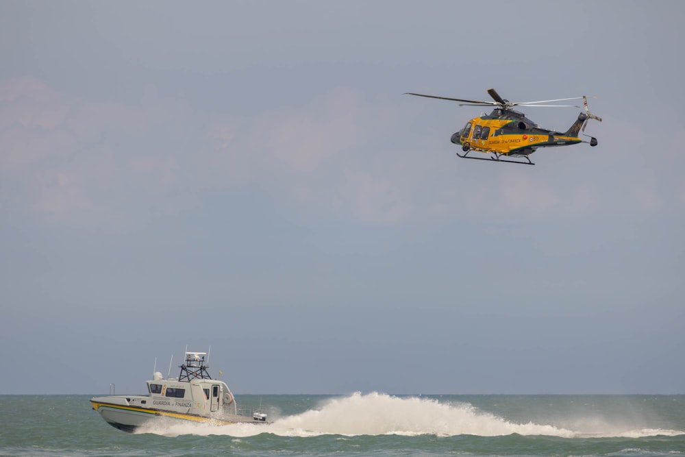 a helicopter flying over a boat in the ocean