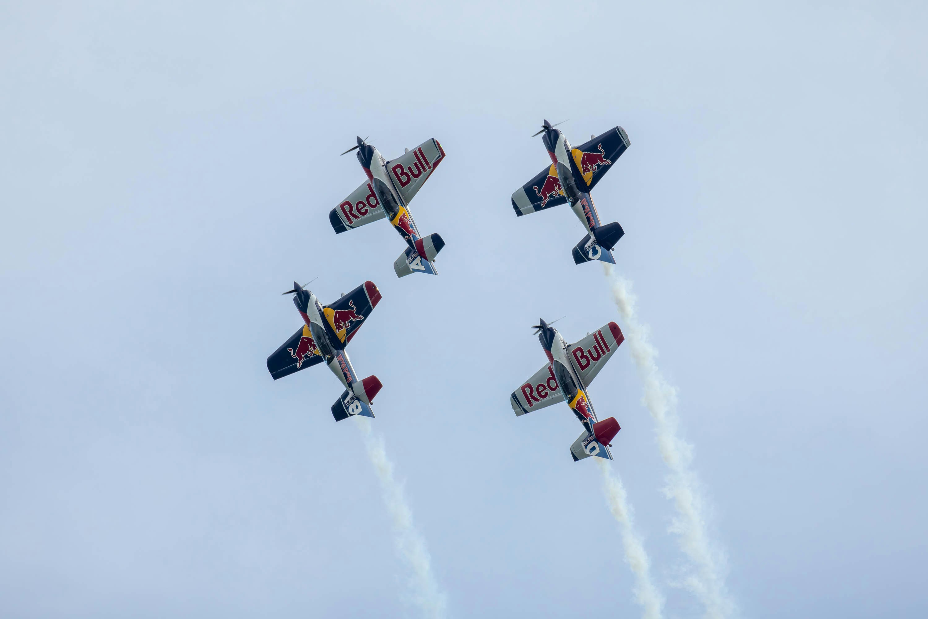 a group of airplanes flying through a cloudy sky